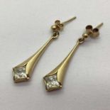A Pair of 9ct Gold Drop Earrings, of fluted form, stone set to bottom, with beaded decoration, (