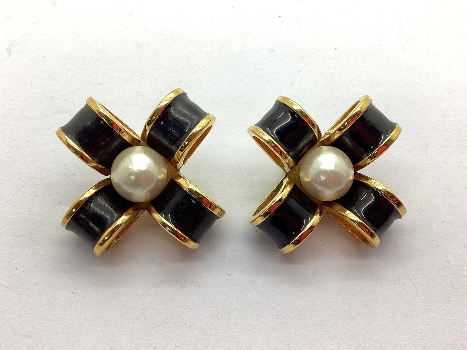 Chanel; A Pair of Black Enamel and Imitation Pearl Bow Clip on Earrings. Yes hinges work as normal
