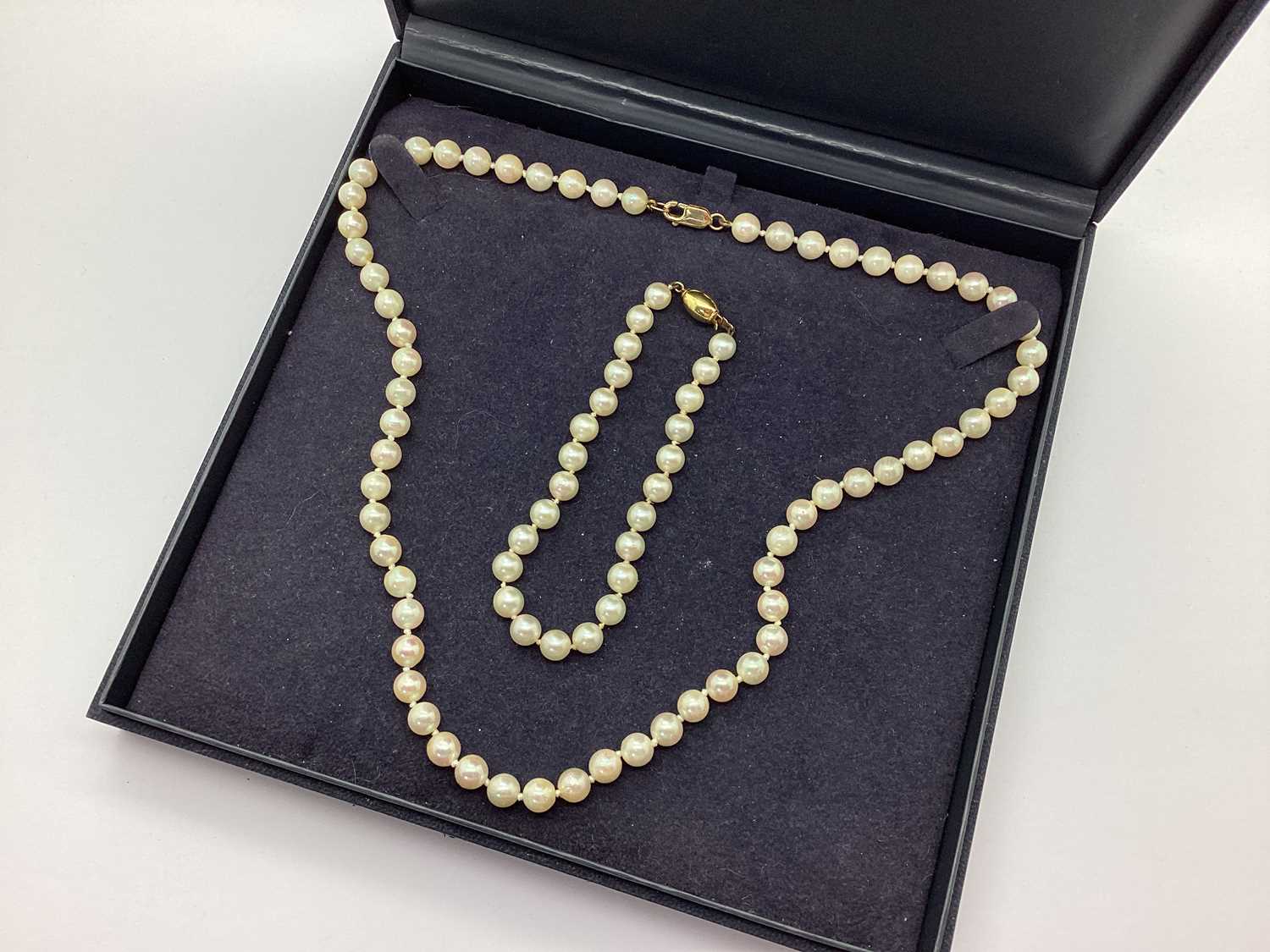 A Pearl Necklace, clasp stamped "375"; together with a pearl bracelet with fishhook clasp stamped "