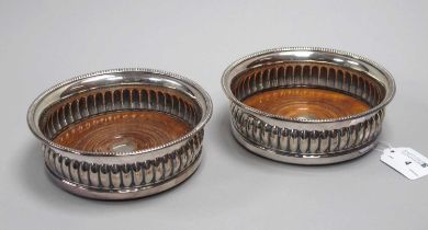 A Pair of Plated on Copper Bottle Coasters, each of gadrooned form with turned wood base, rim 14.6cm