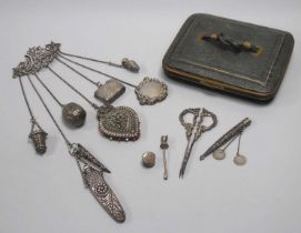 A XIX Century Chatelaine, the shaped scroll brooch (stamped "Sterling") suspending seven chains