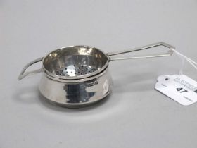 A Hallmarked Silver Tea Strainer on Stand, RP, Birmingham 1939, of Art Deco style with angular