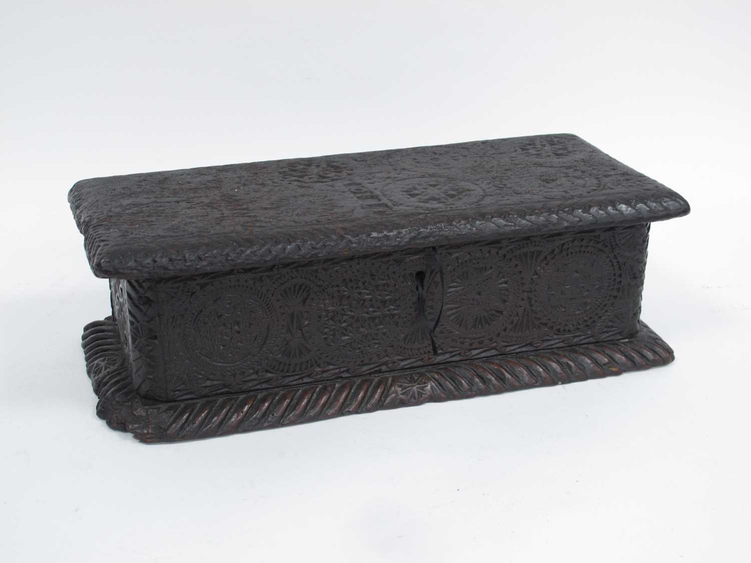 A XVII Century Box, with a hinged cover carved with circles of geometric designs, upon a gadroon