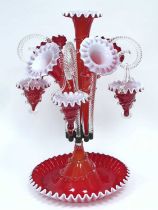 A Late XIX Century Red and White Glass Epergne, the shaped circular base with central trumpet vase