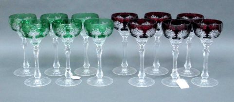 A Set of Six Cut Glass Hock Glasses, the dark ruby flashed bowls cut with flower heads on fluted