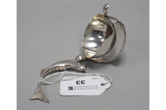 A Novelty Russian Tea Strainer, the handle naturalistically modelled as a fish, with articulated