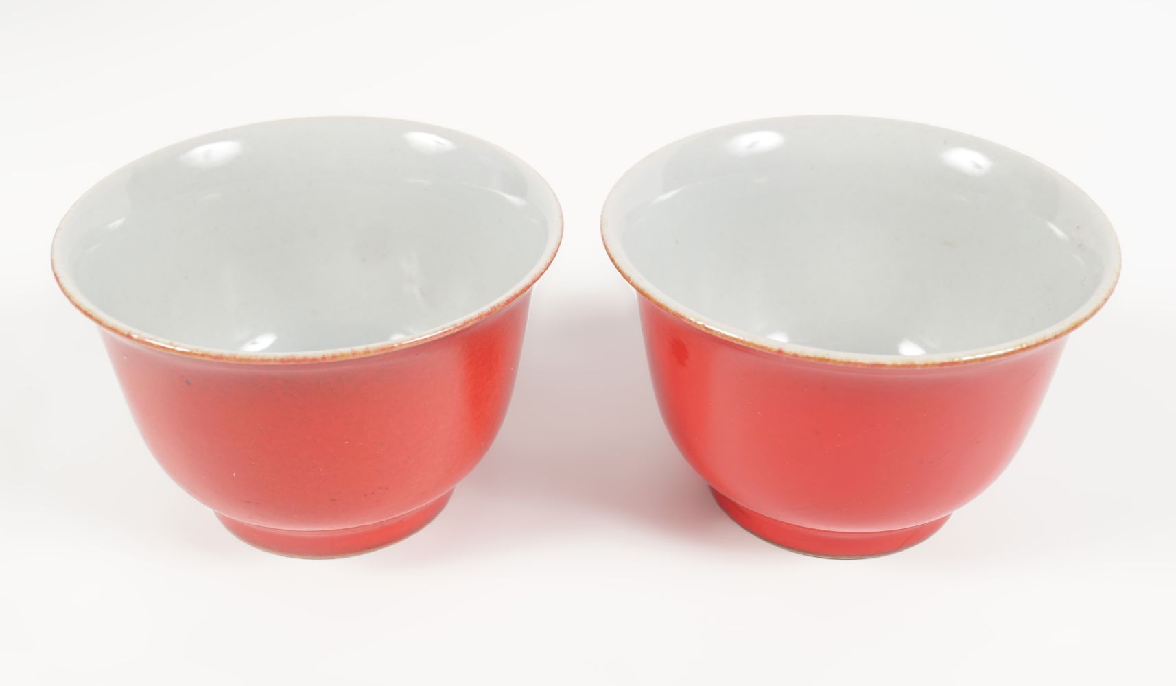 PAIR OF CHINESE QING CORAL GLAZED BOWLS