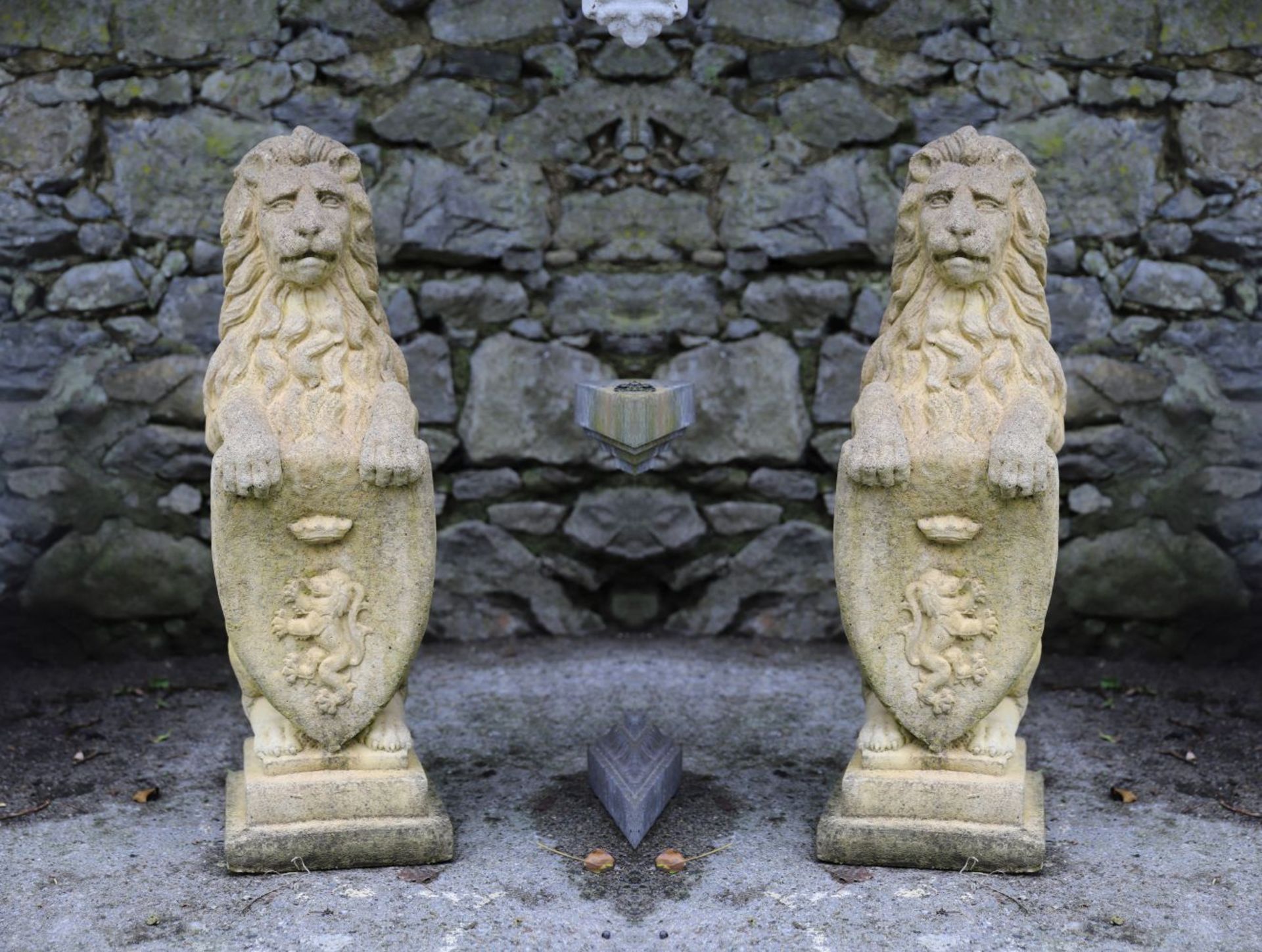 PAIR OF MOULDED STONE GARDEN SCULPTURES