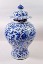 A Qing Dynasty Chinese blue and white baluster vase and cover painted birds and flowers, 41cm