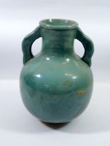 A large green glazed two handled vase, 23cm tall