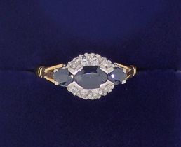 An 18 carat gold ring set three marquise cut sapphires and chip diamonds, size M