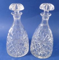 A pair of cut glass mallet form decanters