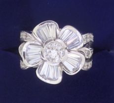 An 18 ct white gold floral cluster ring set white stones, 11g, size P