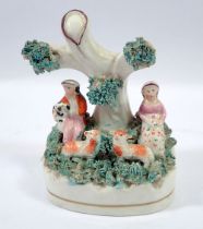 A small Victorian Staffordshire bocage group of seated couple with sheep and dog, 10.5cm