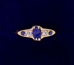 An 18 carat gold ring set three sapphires and two diamonds, size M, sapphire chipped, 3g