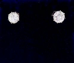 A pair of white gold set diamond stud earrings, just under one carat in total