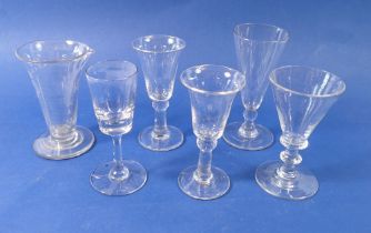 A group of five antique drinking glasses plus a medicine measure