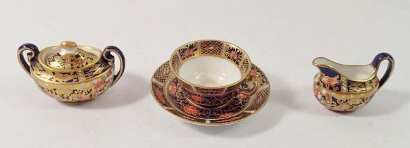 A Royal Crown Derby miniature covered sugar bowl, jug and teacup, 3cm tall