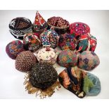 A quantity of childrens embroidered hats from the Middle East and China including Azbechistan,