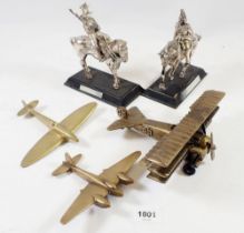 Three brass model aeroplanes and two metal figures of mounted cavalrymen