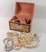 A box of faux pearl jewellery
