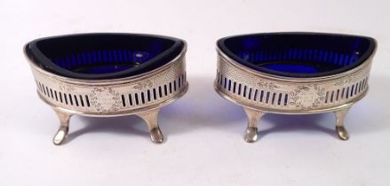 A pair of oval silver boat form salts with engine turned and leaf decoration, laurel cartouche
