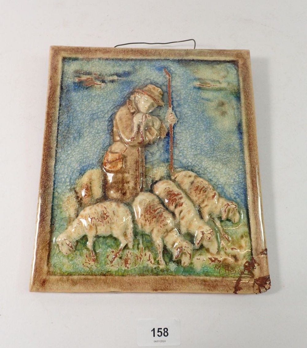 A Karlsruhe Majolica wall plaque depicting Shepherd and Sheep, signed, 24 x 22cm - damaged