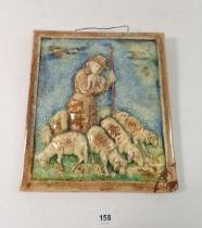 A Karlsruhe Majolica wall plaque depicting Shepherd and Sheep, signed, 24 x 22cm - damaged