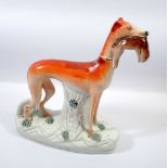 A Victorian Staffordshire large greyhound with rabbit, 28cm tall