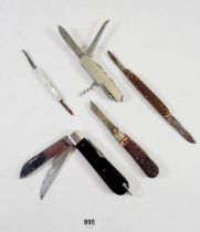 A group of five vintage penknives and belt holder