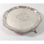 A Georgian silver card tray with armorial, on three hoof feet, London 1765 by Hannam & Crouch, 291g,