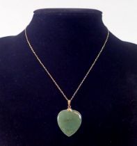 A 14k gold Chinese jade heart form pendant 3cm drop on 14k gold chain 46cm long