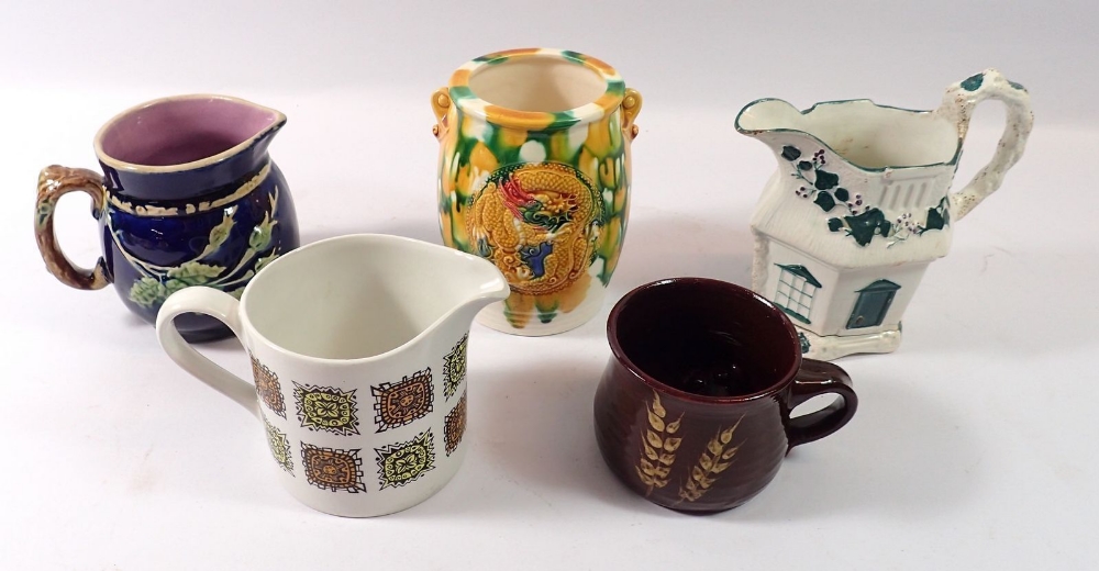 A Victorian Majolica jug, a Majolica glazed pot and three other jugs