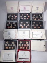 A collection of Royal Mint coin sets including United Kingdom proof sets 1983-1989 plus a deluxe red