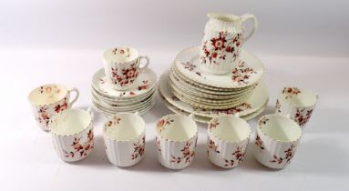 A Victorian floral tea service comprising eight cups and saucers, nine side plates, two sandwich