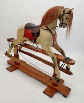 A Victorian Ayres style painted wooden full size rocking horse on turned wood safety stand, 131cm