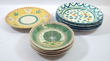 A group of nine tin glazed plates including four peacock plates, 19cm diameter