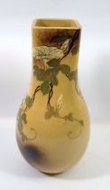 A Japanese Meiji period art pottery vase painted trailing flowers on an ochre ground, impressed