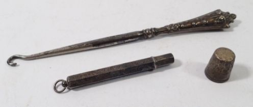 A silver pencil, silver Charles Horner thimble and silver button hook