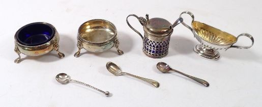 A pair of circular silver salts (only one liner) plus a blue glass lined mustard pot and a silver
