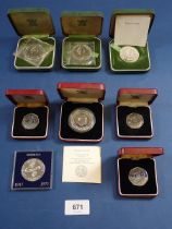 A group of cased coins including silver Elizabeth II 1972 crowns x 3, 1974 Sierra Leone one leone,