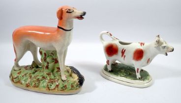 A Victorian Staffordshire greyhound and cow creamer