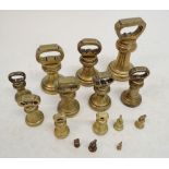 Two sets of antique brass bell weights, eight from 7lbs to 1/4 ozs and a part set