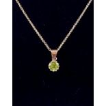 An 18 carat gold peridot pendant necklace and chain, 2.4g, 38cm long