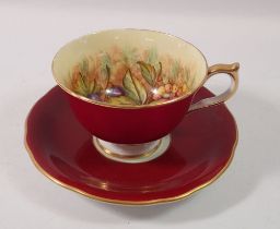 An Anysley tea cup and saucer printed fruit, by James