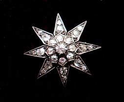 A diamond set star form brooch 3.7cm diameter, 10g, unmarked but thought to be 18ct gold