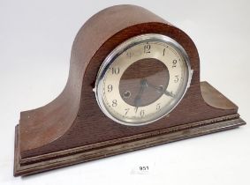 An oak chiming mantel clock