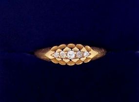 An 18 carat gold ring set five graduated diamonds, size M, 2g