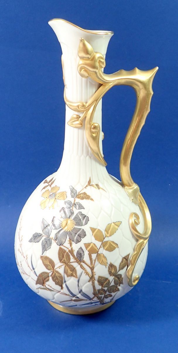 A Victorian Royal Worcester large ivory and gilt jug with trailed stem and leaf handle, painted gilt