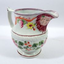 A 19th century Staffordshire Pearlware Bacchus jug with double mask to spout and floral painted